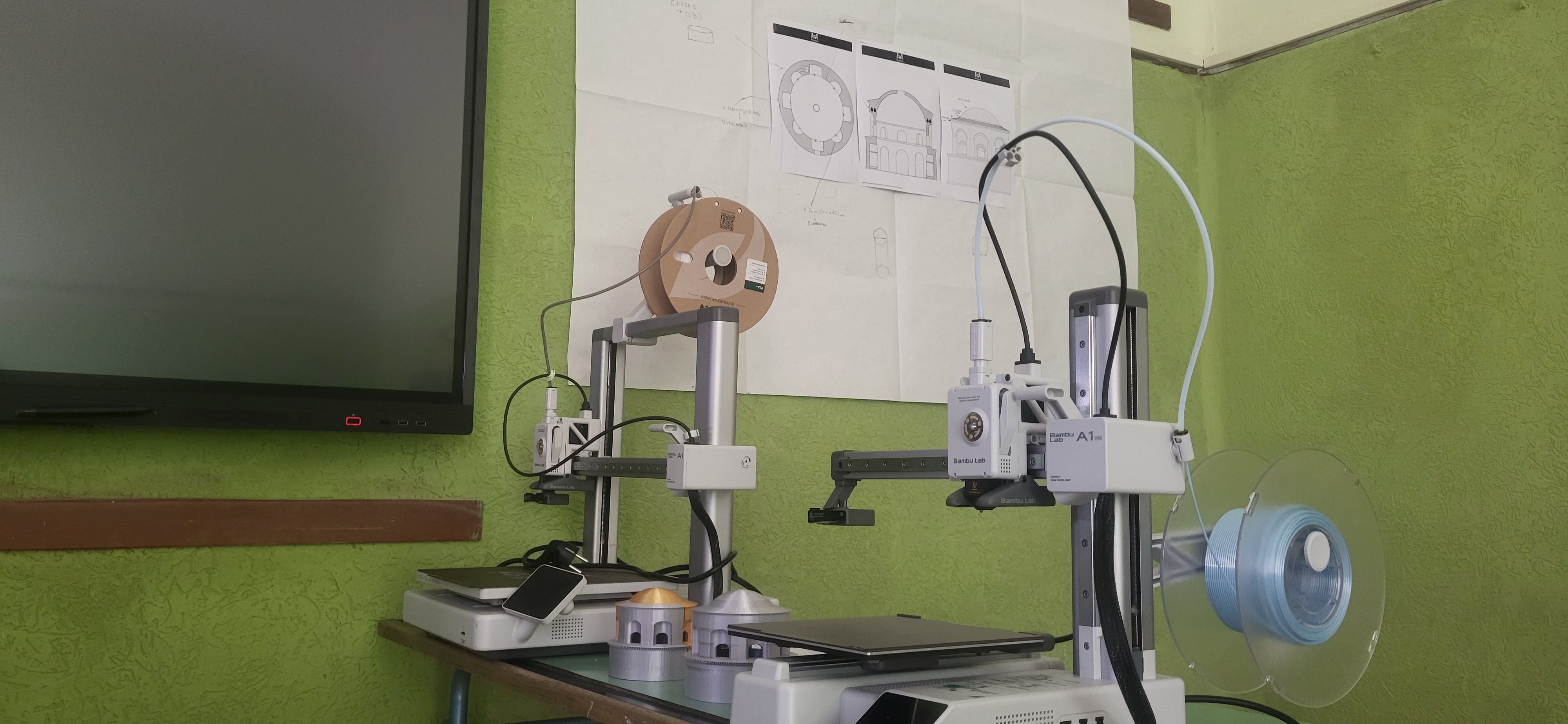Tavole tecniche del mausoleo appese in classe accanto alle stampanti 3D