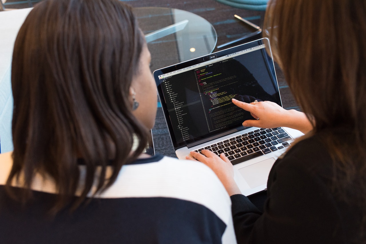 two-women-looking-at-the-code-at-laptop-1181263